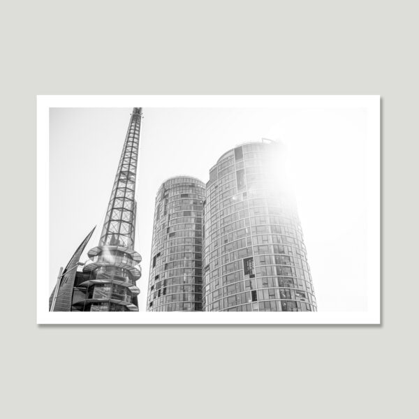 sunlit-structure_th Modern architecture in sunlight – a high-contrast black and white image of curved glass buildings and a steel tower.